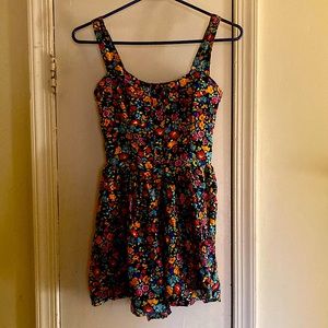 It is a floral and colerful romper. Its brands is wild fable. The size is an XS.